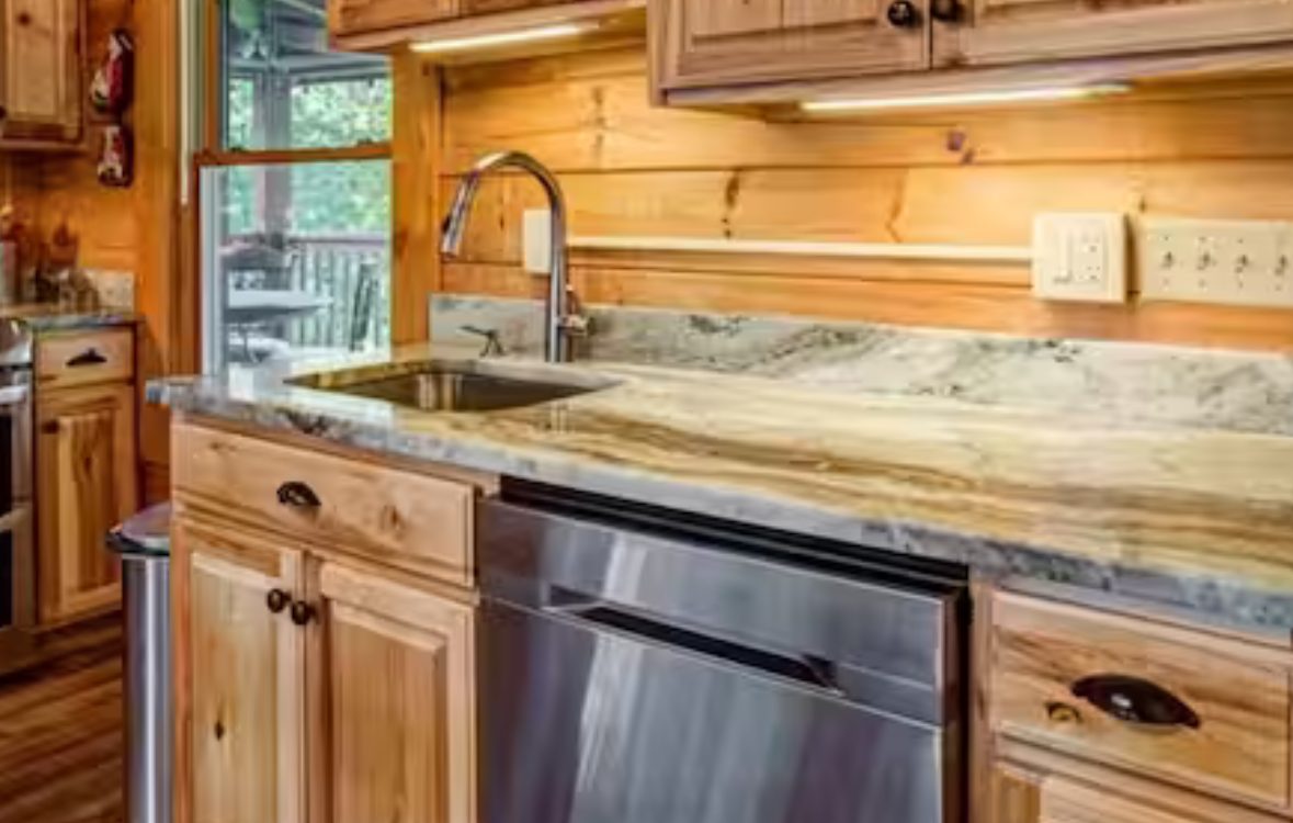 Kitchen sink and granite counter with stainless dishwasher