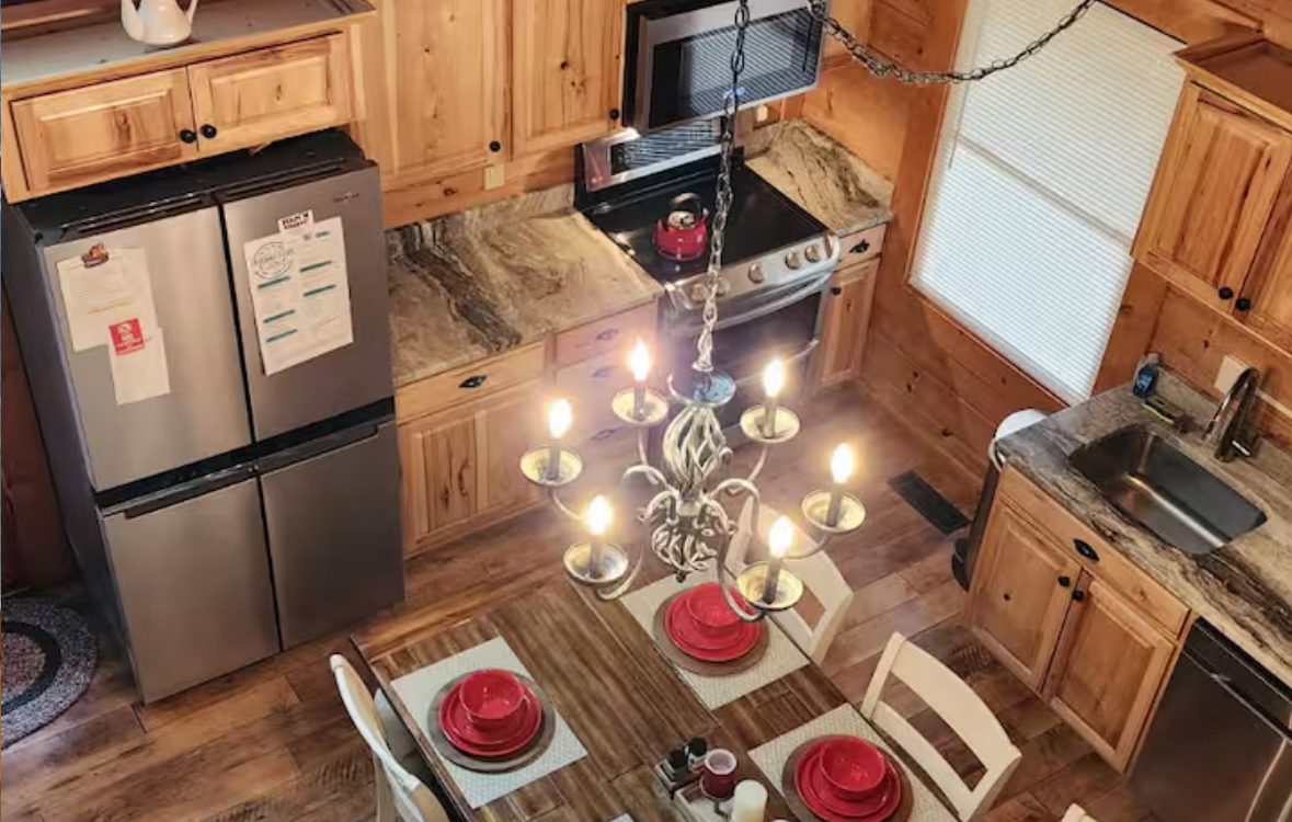 Full kitchen with hickory cabinets and dining table
