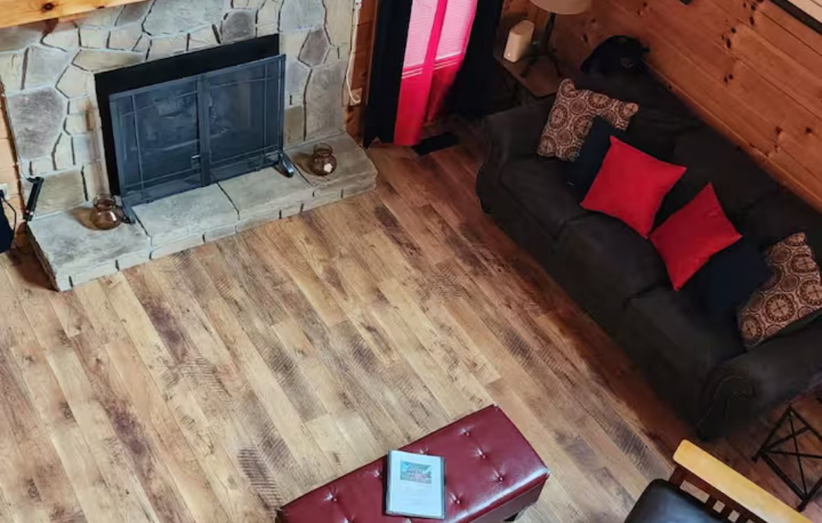 Great room with stone fireplace and leather seating