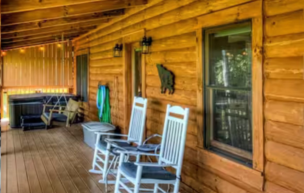 Screened deck with loungers over a green ridge